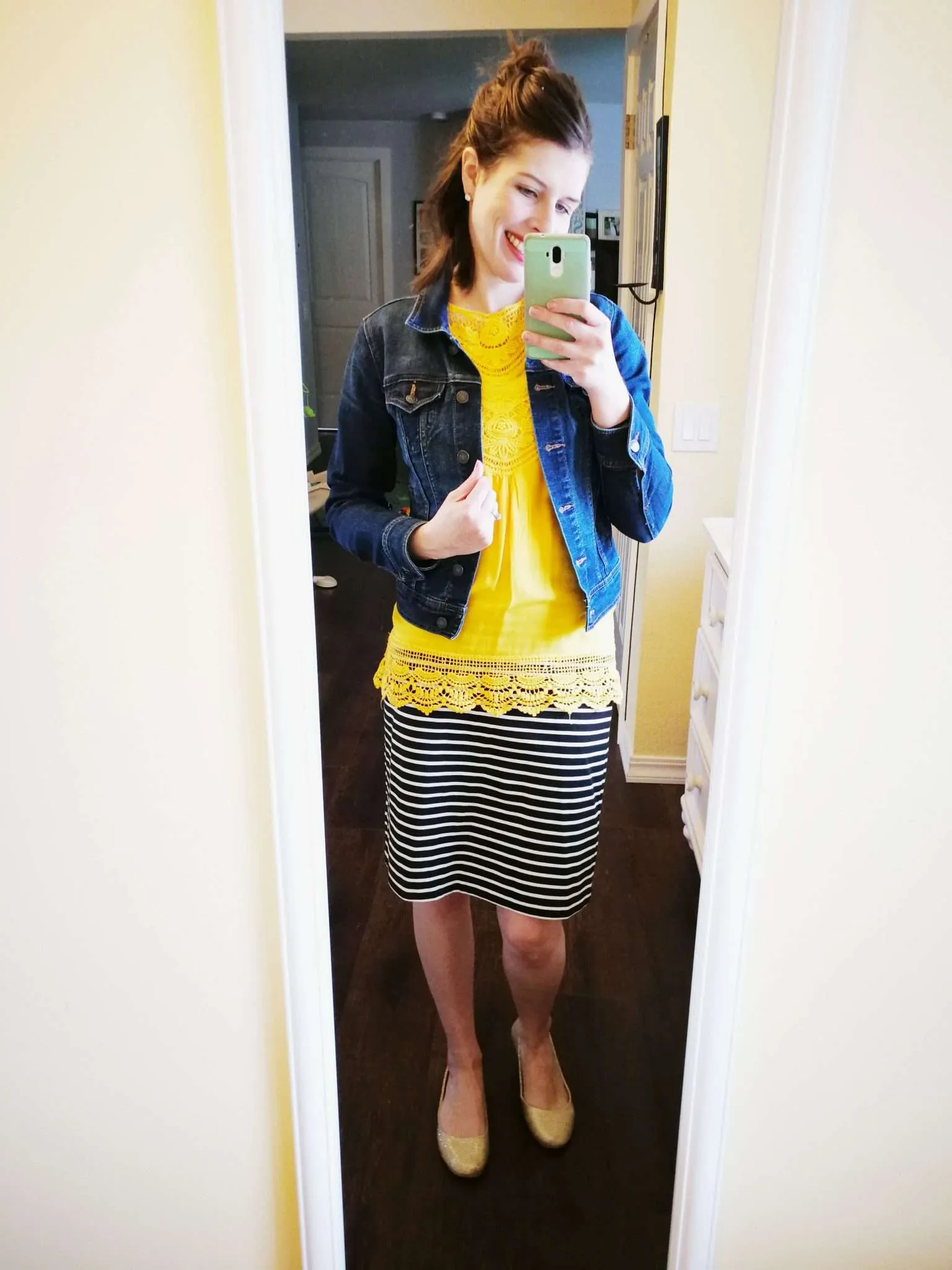 Blouse with lace details untucked with striped pencil skirt.