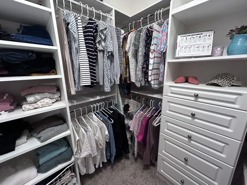 Closet picture showing how to organize a walk in closet. How to organize your tops.