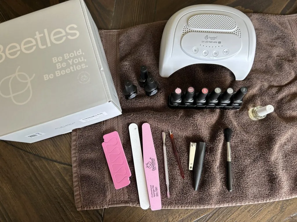 Full Beetles Gel Nail Kit laid out with tools, polish, and LED lamp—ideal starter kit for DIY gel manicures.