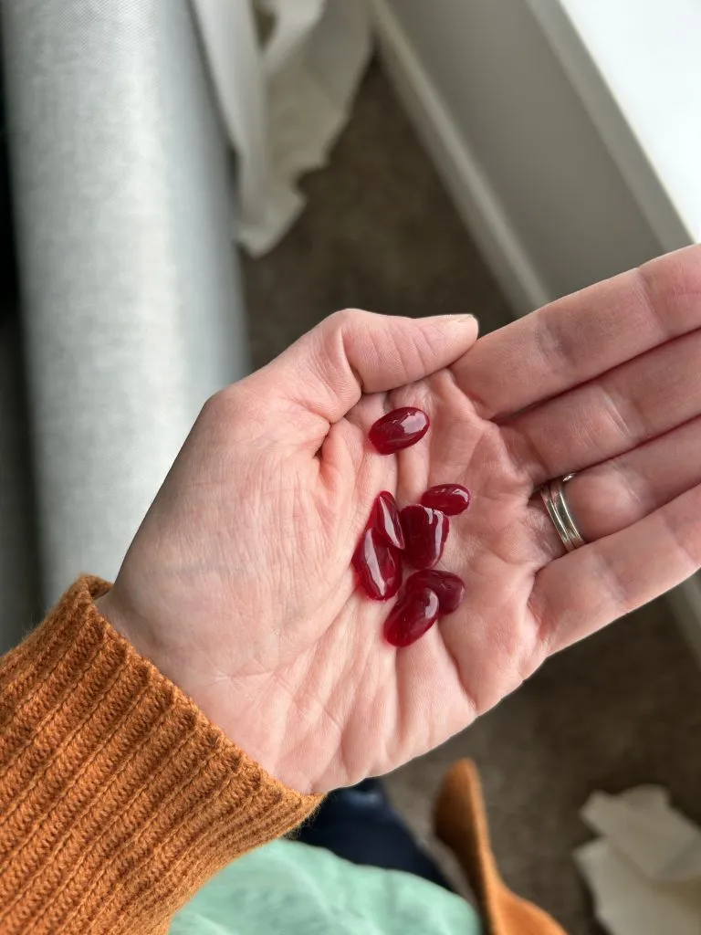 Gel polish peeling off cranberry-colored nails, a common issue with DIY gel manicures without proper prep or base coat.
