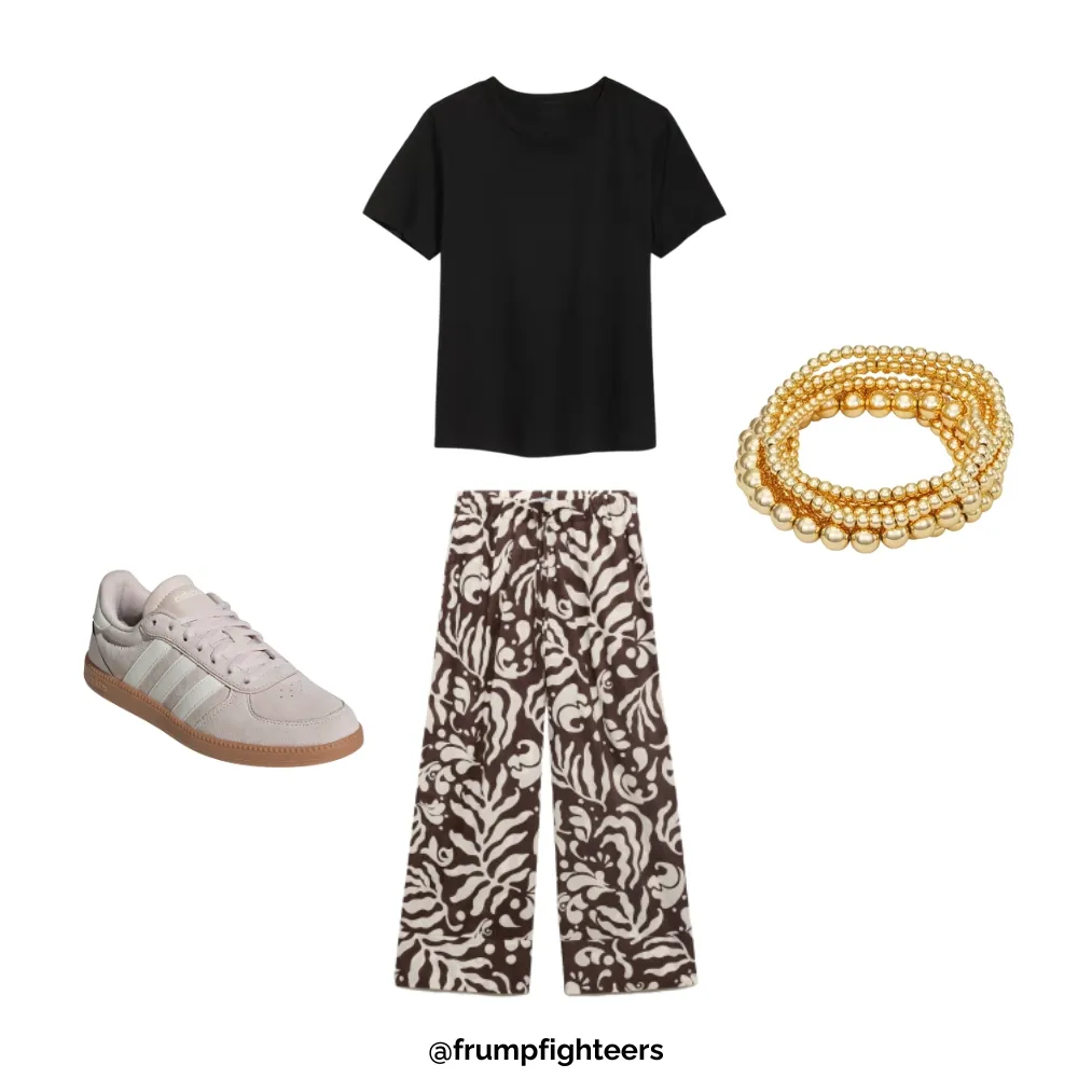 Black tee and patterned wide-leg pants with pink sneakers and gold bracelets as a trendy fall teacher outfit.