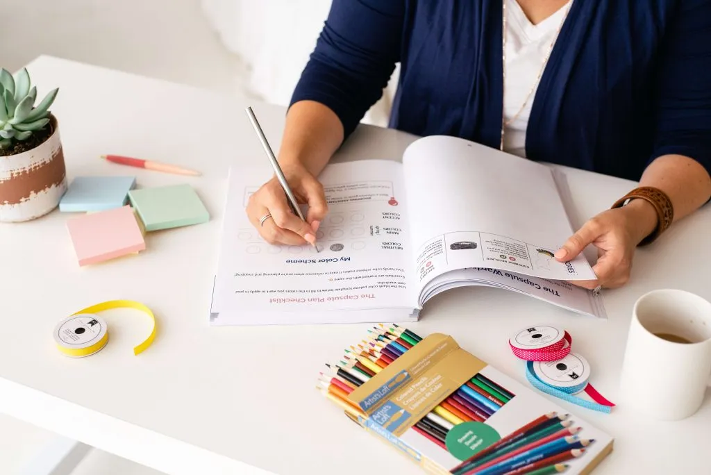 Woman filling out planner, showing how to choose a unique color scheme
