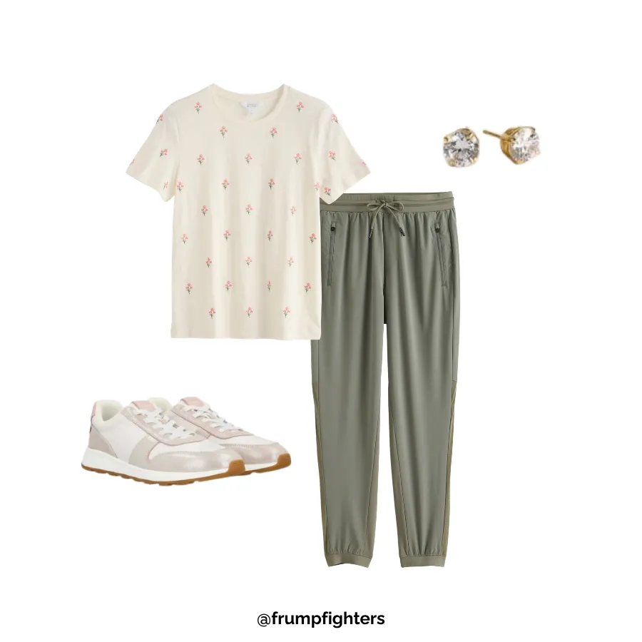 Flat lay of cream floral print tee, sage joggers, lace-up sneakers, and gold stud earrings for a casual mom outfit