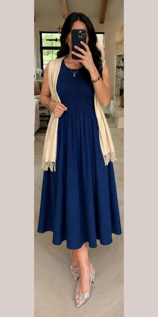 Woman wearing a cobalt blue maxi dress with a champagne wrap and floral slingback flats for a classy summer date night outfit